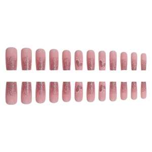 Pink glitter gradient press-on nails with heart patterns in medium long coffin shape