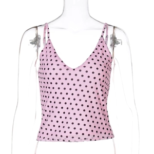 Detail of pink polka dot camisole with thin straps and V-neckline on a mannequin