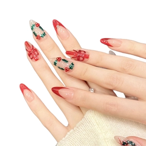 Christmas press-on nails with red bows, green wreaths and almond shape design