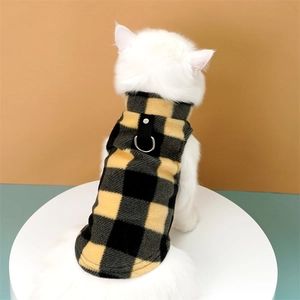 Detail of yellow checkered warm fleece pet vest with metal D-ring for leash attachment