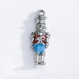 Macro detail of nutcracker soldier pendant with red and blue enamel for DIY jewelry