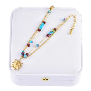 French vintage double-layered beaded bracelet with gold sun pendant on white box