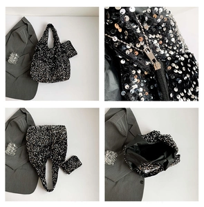 Detail showing shiny black sequin tote bag with matching coin purse and zipper quality