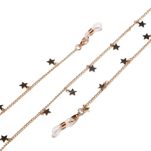 Close-up of golden metal eyeglass chain featuring star charms and adjustable loops