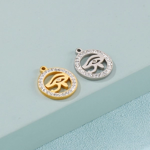 Golden and silver Eye of Horus pendants with sparkling crystal inlay on round metal base
