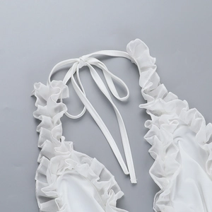Detail of white bikini top featuring ruffle trim and halter neck tie strings