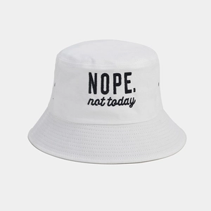 Close-up of white cotton bucket hat featuring black 'NOPE. not today' embroidered text