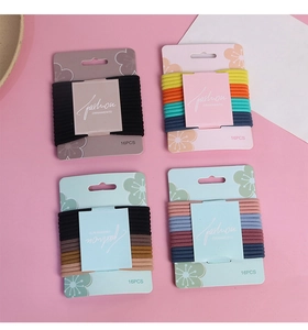 Detail of 16-pack high-elasticity hair ties on display cards with ribbed fabric texture
