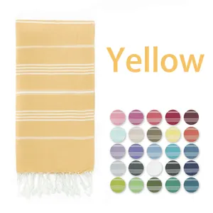 Yellow Turkish beach towel with white stripes and fringe, featuring 25 color swatches