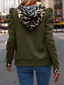 Women's army green hoodie with leopard print patches on hood and sleeves in a street view