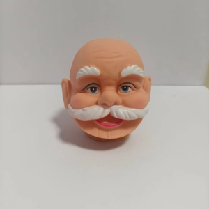 Macro view of 3D vinyl Santa Claus head accessories for DIY Christmas festive ornaments