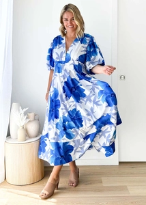 Detail of blue and white floral maxi dress featuring V-neckline and elegant puff sleeves