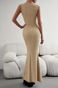 Detail of beige bodycon knit dress showing back cut-out design and pleated fabric texture
