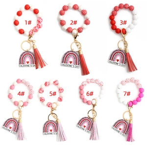 Close-up of heart beaded keychain wristlets with leopard print Valentine tag and tassel