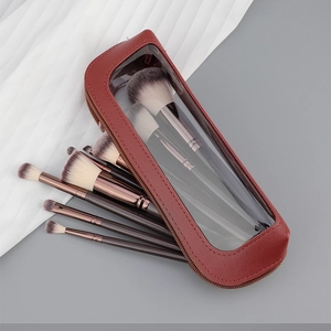 Detail of 10-piece professional makeup brush set with burgundy leather zip pouch