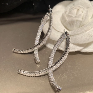 Silver curved crisscross earrings with zircon pavé stones and white camellia flower