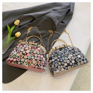 Detailed embroidery on floral shell bags in pink and blue with metal chain straps