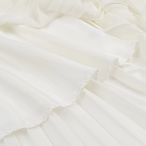 Macro detail of high-quality pleated white chiffon fabric with neat hem stitching