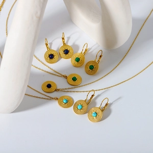 Detailed view of vintage gold-plated necklaces and earrings with turquoise stone inlays
