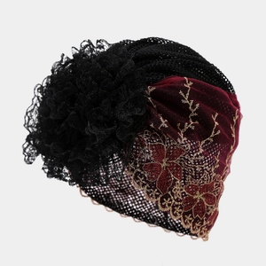 Detailed embroidery and golden floral patterns on elegant red lace headscarf hat