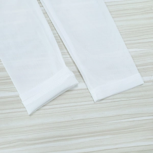 Close-up of white mesh fabric showing transparent texture and hemmed sleeve detail
