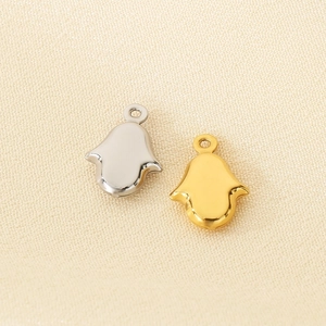 Detailed view of silver and gold Hamsa hand charms for DIY jewelry making accessories