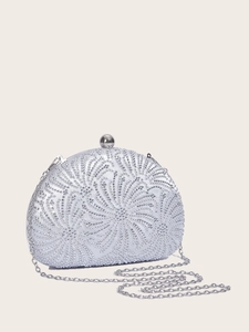 Close-up of sparkling rhinestones and silver spherical clasp on evening shell clutch bag