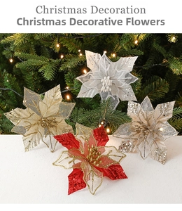 Close-up of glittery mesh poinsettia flowers in red, white, and gold for Christmas decor