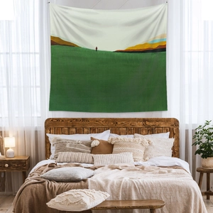 Detail of bohemian tapestry texture and abstract landscape hanging on bedroom wall