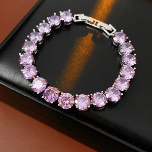 Macro shot of purple round-cut cubic zirconia tennis bracelet on black leather box