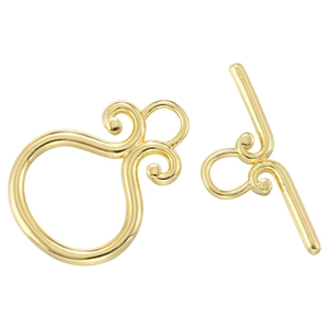Detailed view of vintage gold plated OT clasp with ornate floral scroll texture