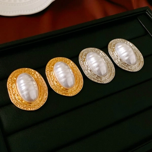 Vintage oval imitation pearl earrings with hammered metal frames in gold and silver
