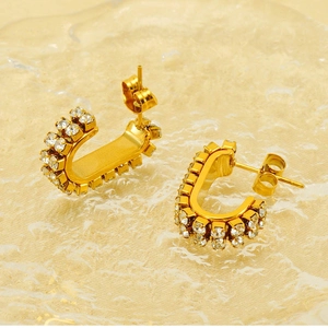 Detail view of U-shaped gold earrings with double rows of sparkling cubic zirconia