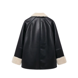 Detail view of the back of a black faux leather jacket with cream fleece trim and seams