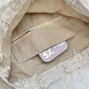 Detailed close-up of the canvas tote bag interior with a secure zipper inner pocket