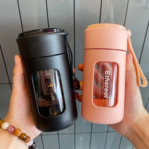 Close-up of portable matte water bottles in pink and black with transparent window