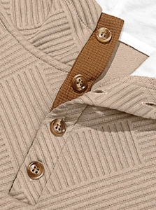 Macro shot of khaki knit texture and brown button details on men hoodie collar