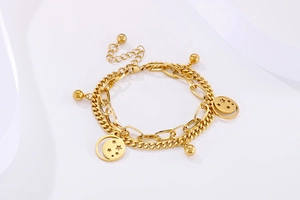 Detailed view of gold double-layer bracelet with hollow star charms and round beads