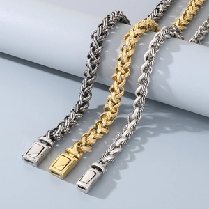 Detailed view of woven twist bracelets in gold, silver, and black stainless steel
