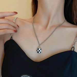 Minimalist silver checkerboard square pendant necklace set worn by model for chic style