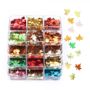Macro view of 6-color laser maple leaf nail sequins in a clear organizational storage box