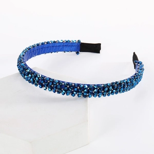 Detailed close-up of handmade double-row blue crystal beaded headband with satin lining