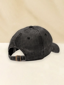 Detailed back view of vintage washed black baseball cap with adjustable metal buckle strap