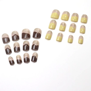 Glossy chocolate brown and cream press-on nails with minimalist curved French tip design