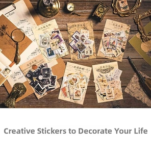 Vintage botanical and insect stickers arranged with an antique magnifying glass on wood
