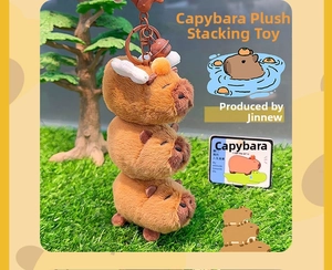 Close-up of triple stacked Capybara plush keychain with brown metal ring and bell detail