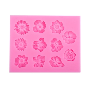 Pink silicone cake mold with 11 assorted flower shapes like roses and daisies for DIY