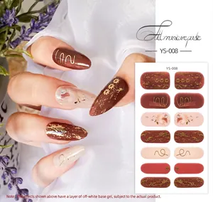 Detail of YS-008 nail wraps featuring gold floral patterns and deep red finish