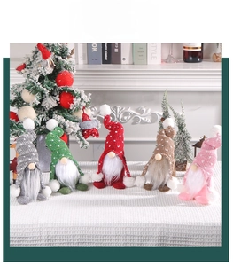 Group display of five colorful knitted Christmas gnomes with white polka dot hats and soft beards