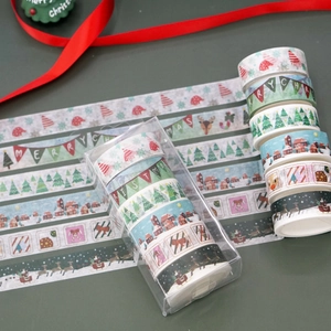 Close-up of 6-roll Christmas washi tape set with reindeer and tree patterns in a gift box